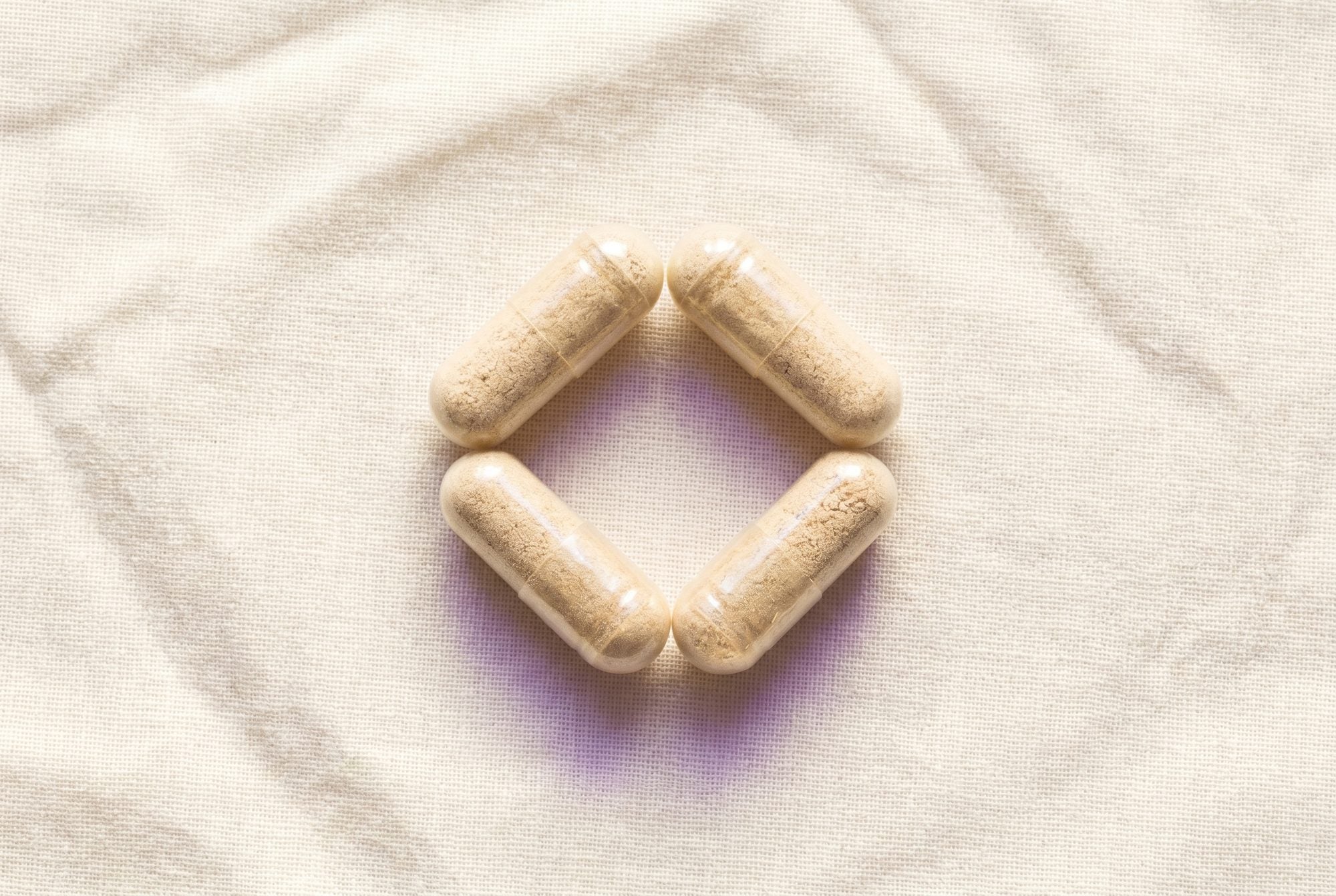 Four plant-based capsules arranged in a hexagonal pattern, representing the four cultures of the Clarity Quartet
