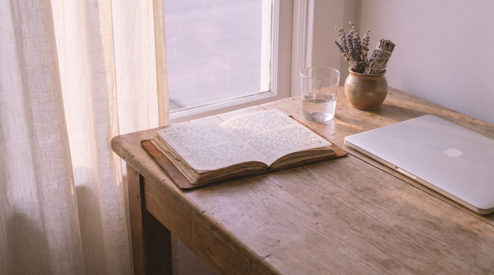 A calm morning by the window &mdash; soft light, a journal, a glass of water, and dried lavender